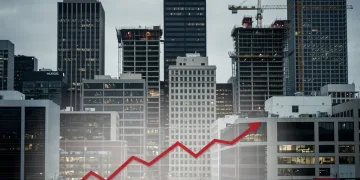 Modern city skyline with commercial buildings, symbolizing real estate market challenges and devaluation trends.